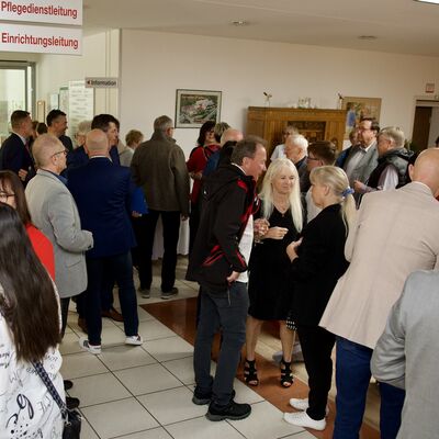 Bild vergr&ouml;&szlig;ern: Viele G&auml;ste stehen in einem hellen Foyer zusammen und unterhalten sich bei einer Festveranstaltung der AWO Vogtland.